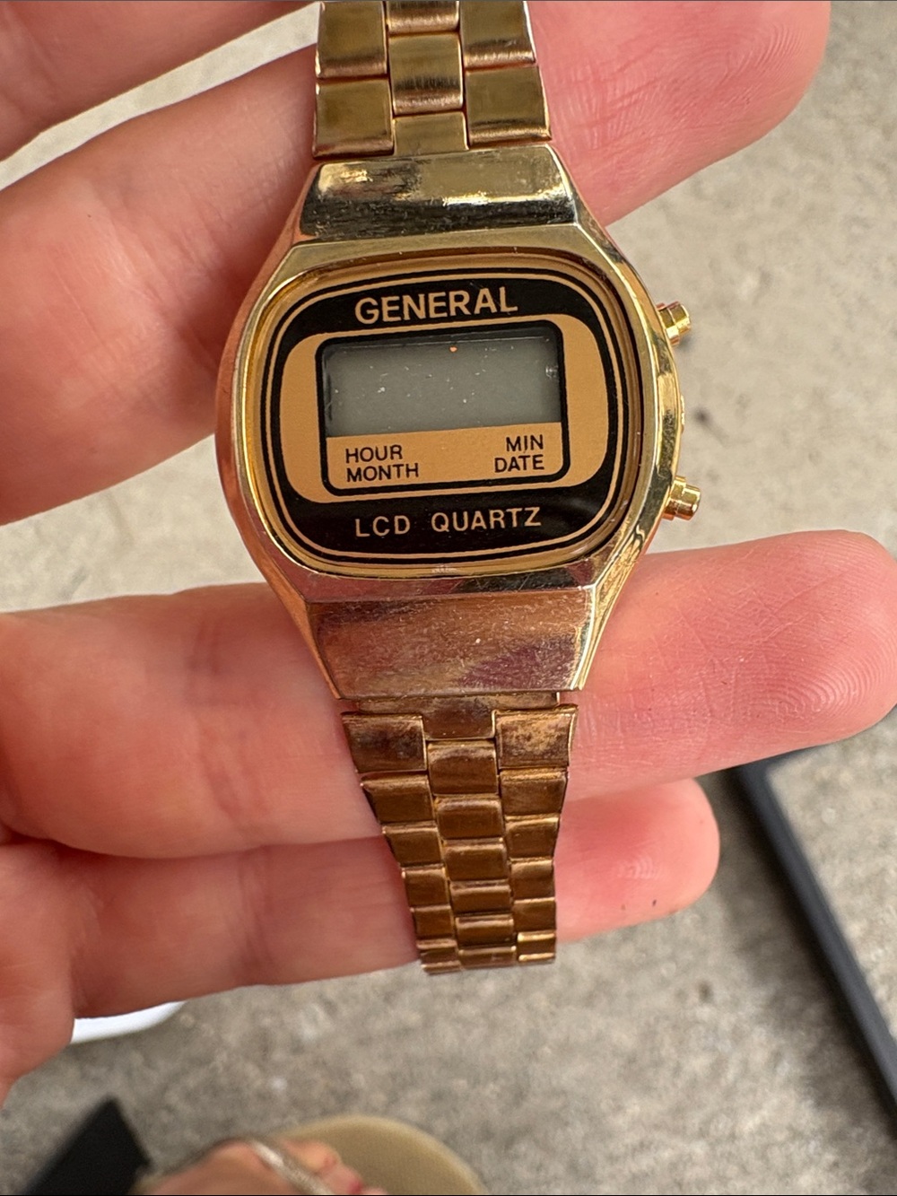 retro digital display and linked metal band typical of 1980s timepieces.